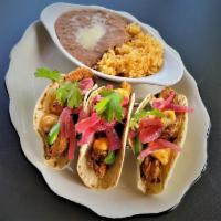 Shrimp Tacos · Breaded Shrimp on a Tortilla of your choice. Top with Pickled Onions and Jalapeno , finish w...