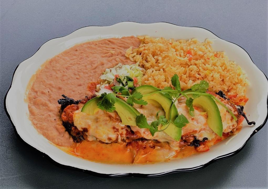Zacatecano Steak · Marinated grilled skirt steak on a bed of onions and peppers, topped with grilled shrimp, melted queso, avocado slices and salsa ranchera. Served with mexi-rice & beans.