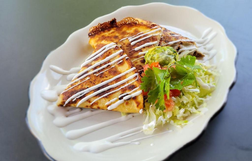 Grill-Chicken Quesadilla · Giant flour tortilla grilled with choice of meat and melted cheese. Served with rice and beans.