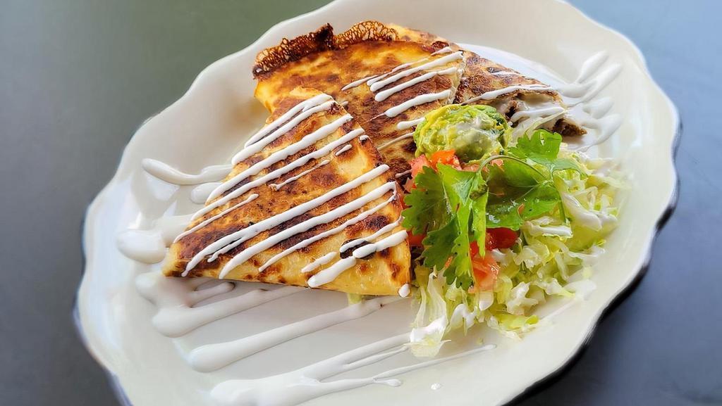 Cheese Quesadilla · Giant flour tortilla grilled with choice of meat and melted cheese. Served with lettuce, tomato, sour cream and guacamole.
