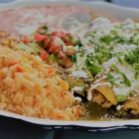 Enchiladas Verdes · Three shredded chicken enchiladas, tomatillo salsa verde, shredded cheese & sour cream. Serv...