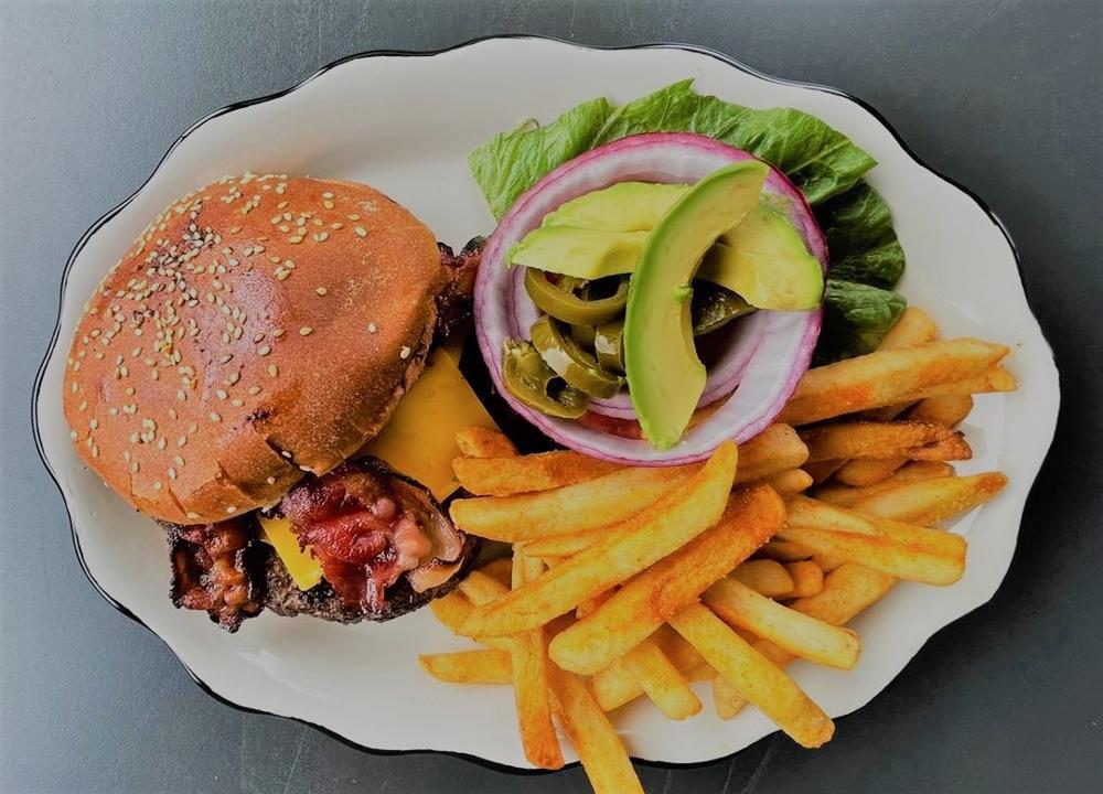 Hamburguesa Con Queso · 8 oz angus beef burger, with avocado, jalapenos, bacon strips, cheddar, lettuce & tomato. Served with seasoned french fries.