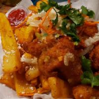 Patatas Bravas · Deliciously fried and golden potatoes topped w/ shaved manchego and tossed in our house blen...