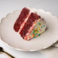 Red Velvet Cake Slice · A slice of our moist red velvet cake with chocolate chips, frosted with vanilla buttercream ...