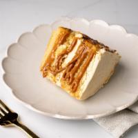 Dulce De Leche Cake Slice · A slice of our moist vanilla cake injected with dulce de leche and frosted with dulce de lec...