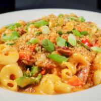Cajun Shrimp & Andouille Mac · Shrimp, andouille, peppers, onions, Cajun seasoning cavatappi pasta, garlic cheese sauce, bu...