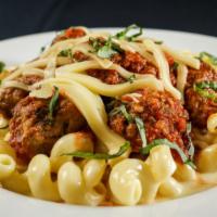 The Meatball Mac · Jumbo braised meatballs served over bucatini pasta, Pomodoro sauce baked with fontina cheese.