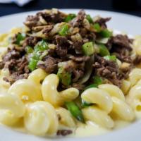 Philly Cheesesteak Mac · Sliced roast beef, peppers, onions, and white cheddar cheese sauce baked with cavatappi pasta