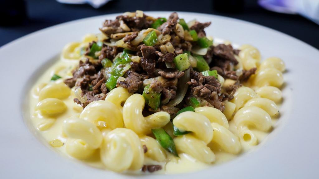 Philly Cheesesteak Mac · Sliced roast beef, peppers, onions, and white cheddar cheese sauce baked with cavatappi pasta