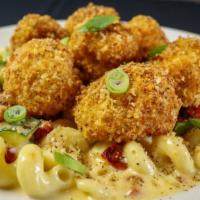 Cauliflower Mac · Parmesan crusted cauliflower lightly fried, topped with black pepper parmesan baked over Cav...