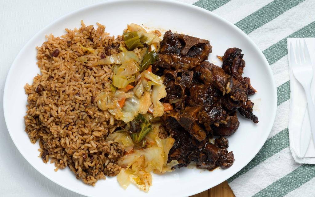 Oxtails · Oxtails  stewed on a brown sauce with a preparatory blend of vegetables, herbs and spices.