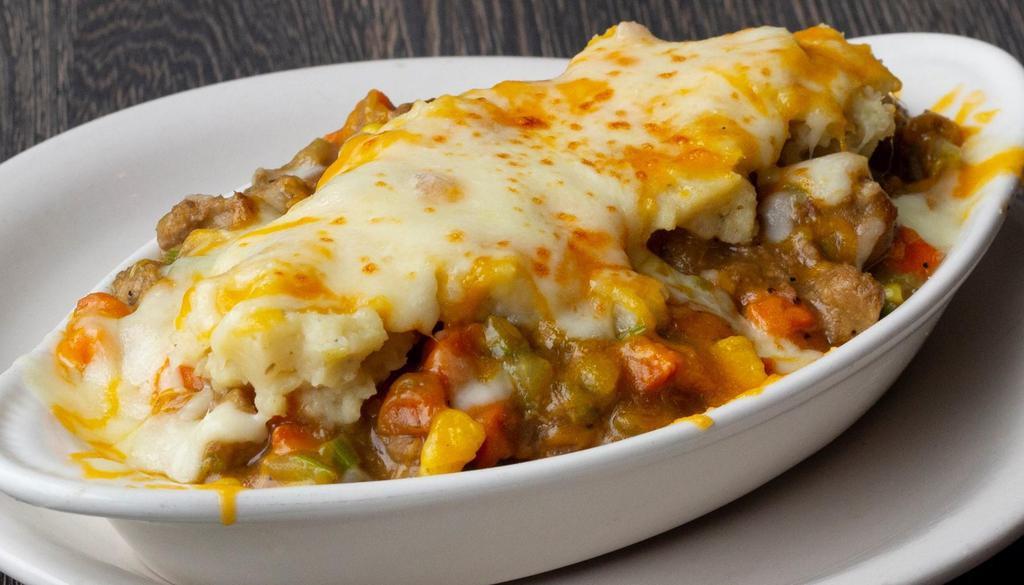 Shepherd'S Pie · Seasoned ground beef and pork, carrots, celery and corn in a rich brown sauce, topped with creamy mashed potatoes and mixed cheese.