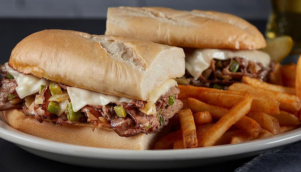 Philly Cheese Steak · Roasted and seasoned beef topped with grilled onions and peppers, melted provel cheese on a toasted hoagie roll.