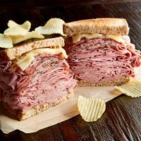 The New York Yankee Regular · 3/4 pound combo of hot corned beef and pastrami, Swiss on toasted marbled rye. Served with c...