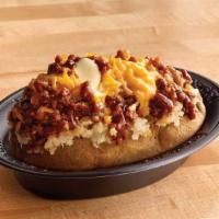 Texas Style Spud Original · Chopped pit-smoked beef brisket, barbecue sauce, cheddar, butter on a baked potato.