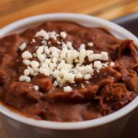 Side Frijoles Dip · small side of our house made frijoles dip. Can be made vegan if cheese garnish is removed.