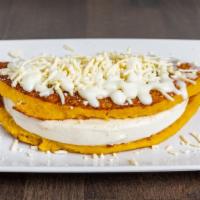 Cachapa With Cheese · Sweet corn tortilla filled with cheese. Grated white cheese on top and cream on the side / T...