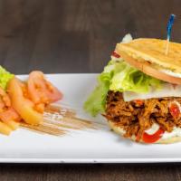Mechada · Arepa filled with shredded beef, De Mano cheese, lettuce, tomato, green sauce and ketchup / ...