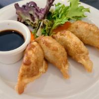 Fried Port Gyoza (4Pcs) · Pork dumplings with soy ginger vinaigrette dipping sauce.