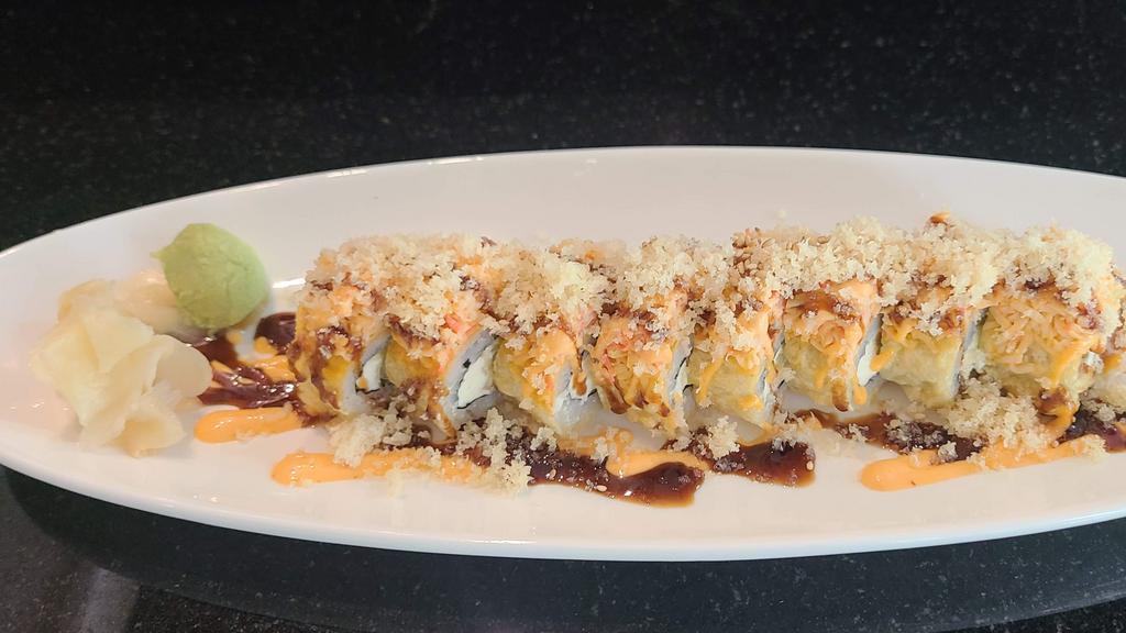 Golden Tiger Roll · Shrimp tempura, cream cheese, avocado. Deep fried and topped with spicy crab, tempura flake, eel sauce, spicy mayo