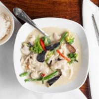 Green Curry · Mildly spicy. Broccoli, green bean, eggplant, green pepper, and basil leaves simmered in gre...