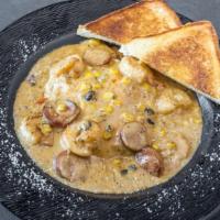 Shrimp And Grits · Grilled Cajun shrimp, fire-roasted corn and Andouille pork sausage over Cheddar stone ground...