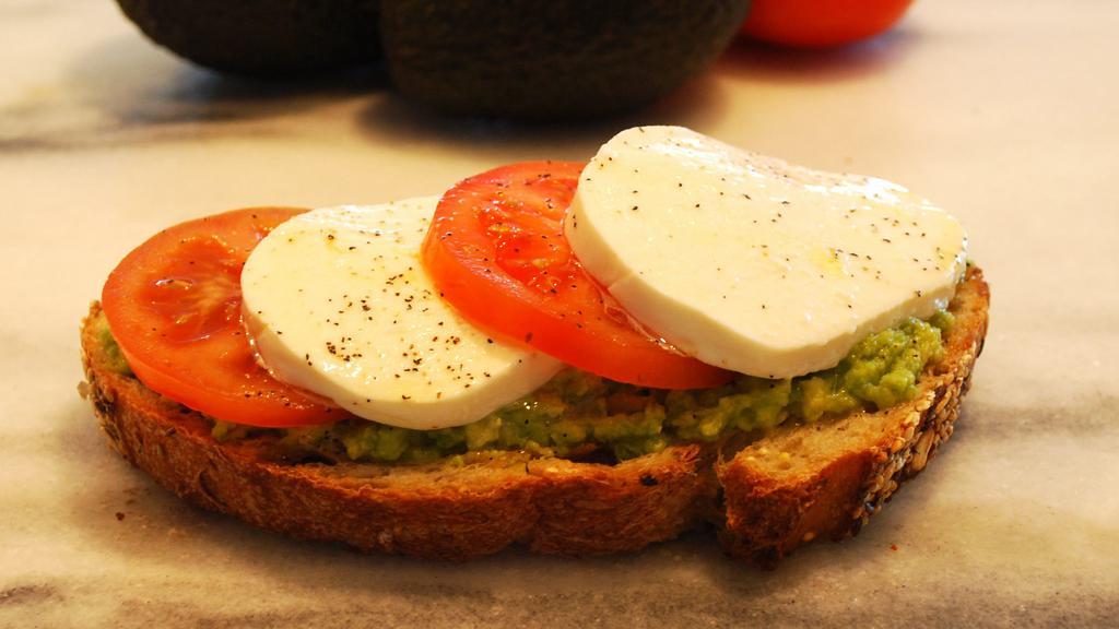 Caprese Avocado Toast · Freshly baked Multigrain toast, avocado, fresh mozzarella, tomato