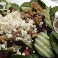Spinach Salad · Baby spinach, tomatoes, cucumbers, red onions, craisins, walnuts, and goat cheese with balsa...