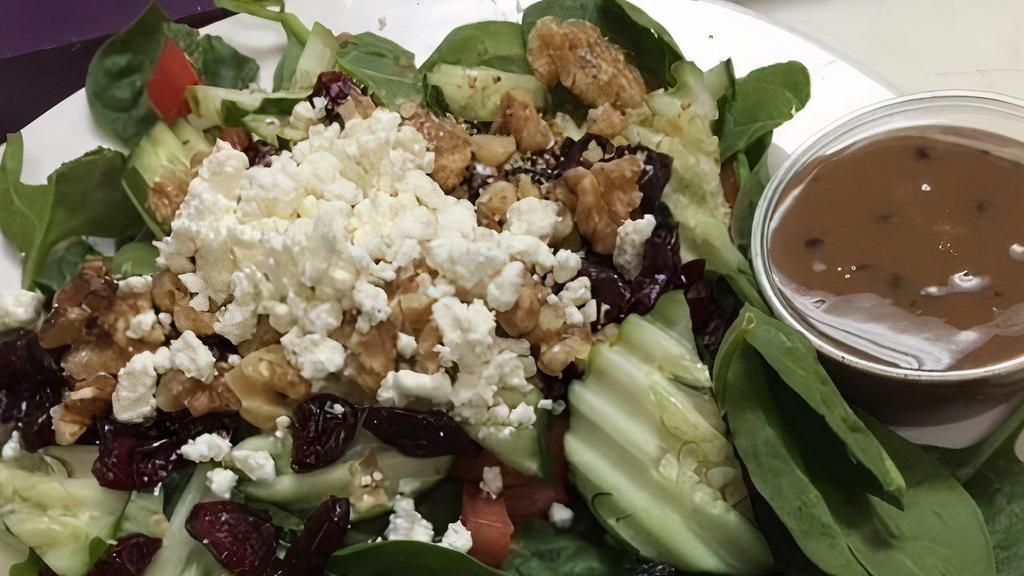 Spinach Salad · Baby spinach, tomatoes, cucumbers, red onions, craisins, walnuts, and goat cheese with balsamic vinaigrette.