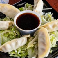 Pot Stickers · Asian spiced pork, vegetables wrapped in flour dumplings, and steamed with a side of soy gin...