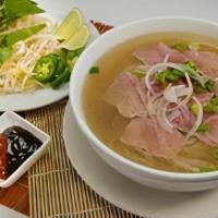 P2 - Pho Tai · A layer of thin, rare eye round steak is cooked by the beef broth right in your bowl, bringi...
