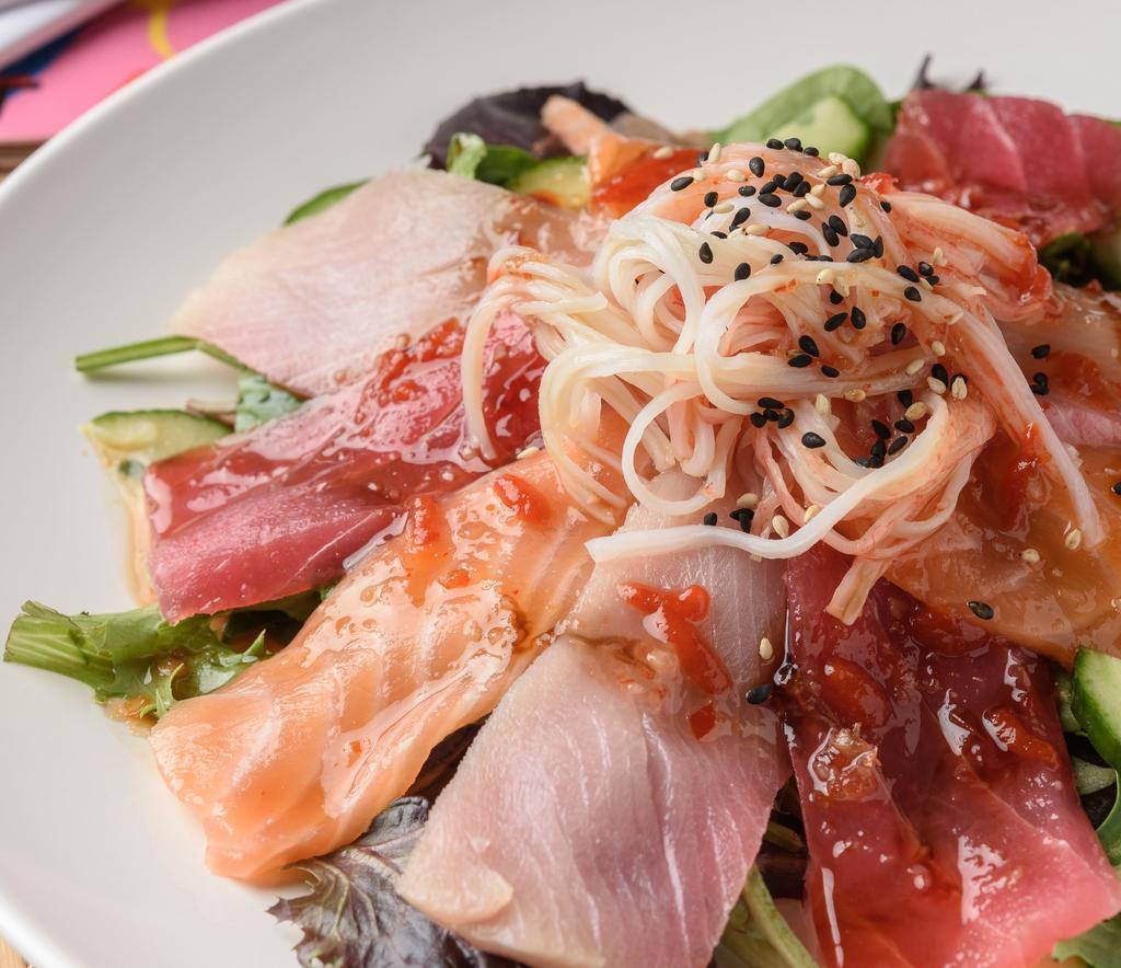 Sashimi Spicy Salad · Three sashimi rockstars- red tuna, salmo, yellowtail- crab stick and cucumber piled on spring mix with sweet chili, ponzu, sriracha, eel sauce and seasame seeds.