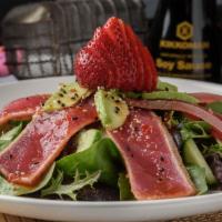 Ahi Tuna Salad · Open wide and say AHI. Just-seared tuna slices, cucumbers, avocado and strawberries piled on...