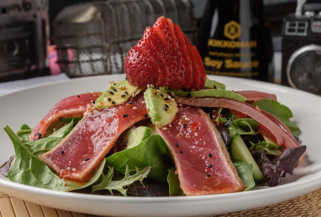 Ahi Tuna Salad · Open wide and say AHI. Just-seared tuna slices, cucumbers, avocado and strawberries piled on spring greens, topped with sweet chili, ponzu and sesame seeds.