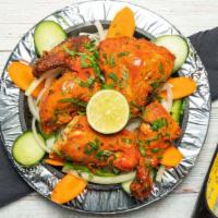 Tandoori Chicken · Chicken marinated in yogurt with blend of colorful Indian herbs spices and roasted in clay o...