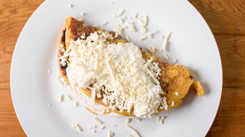 Cachapa Con Queso Y  Carne Mechada O Chiken · Sweet corn tortilla with your choice of white cheese  venezuelan-style shredded chicken, or venezuelan-style shredded beef