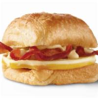 Bacon, Egg & Swiss Croissant · A fresh-cracked grade A egg and Applewood smoked bacon covered in creamy swiss cheese sauce ...