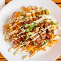 Dirty Kimchi Fries · Freshly fried shoe-string fries mix with homemade kimchi slaws, cilantro, purple onions, and...