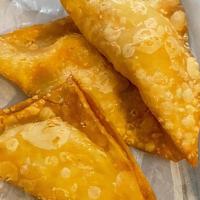 Golden Fried Samosas · Served with mint, mango and tamarind chutney.