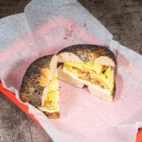 Eggel Bagel · Toasted Bagel of your choice with two scrambled eggs, American cheese and your choice of bac...