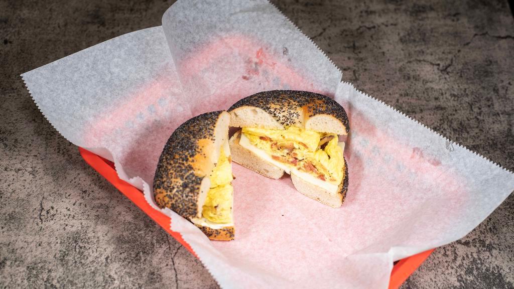 Eggel Bagel · Toasted Bagel of your choice with two scrambled eggs, American cheese and your choice of bacon, ham or sausage. This sandwich also comes with soda or coffee.