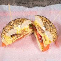 West Coast Bagel · Toasted bagel of your choice with two scrambled eggs, bacon, swiss cheese, avocados, red oni...