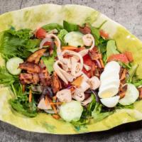 Cobb Salad · Spring mix, carrots cucumbers, onions, tomatoes, cheddar cheese, bacon hard boiled egg & tur...
