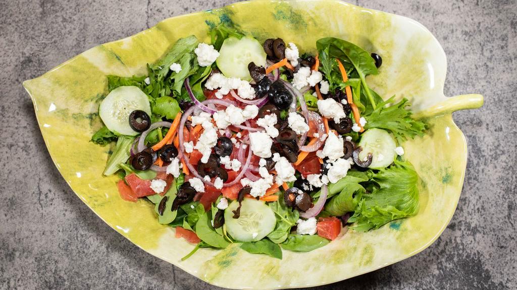 Greek Salad · Cucumbers, red onions, black olives, and feta cheese over a bed of fresh spring mix.