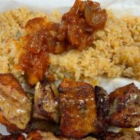 Chicken Kabobs · Marinated chicken breast cubes with onions and bell paper on skewer.