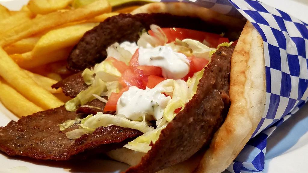 Lamb Gyro · Greek-style seasoned lamb cooked on a spit wrapped in a pita with lettuce, tomato, and a side of tzatziki sauce.