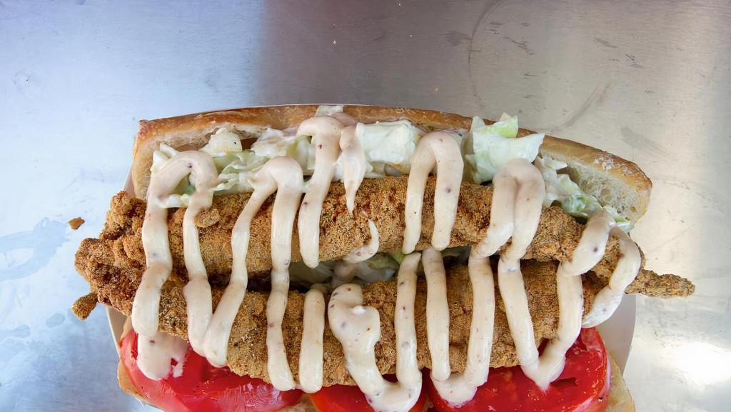 Catfish Po Boy · Deep-Fried Catfish with lettuce  tomatoes  onions  and pickle  on a cub srved with fries and Asian coleslaw