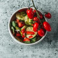 Cucumber Salad · Cucumbers, tomatoes, onion, cilantro lemon, lime, and salt