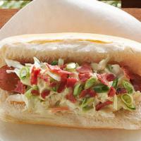 Asian Slaw Dog · Two hot dogs on a bun topped with Asian Coleslaw and fries.