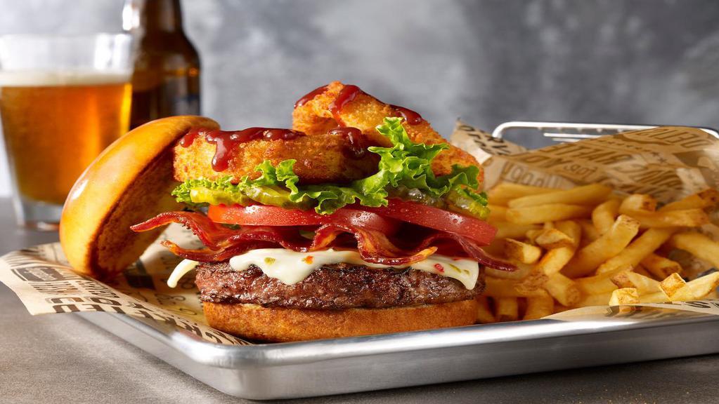 Wild West Burger (1720 Cals) · Our seasoned steakburger topped with Pepper Jack cheese, Applewood smoked bacon & onion rings, finished with Pit Boss BBQ sauce, pickles, leaf lettuce & tomato.
